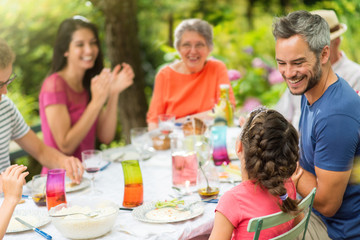  Multi-generation family having lunch in the garden