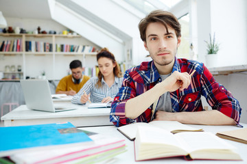 Pensive learner listening to lecturer at lesson