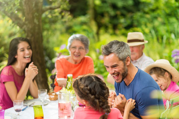 Three generations family having lunch in the garden