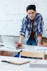 Creative designer standing by his workplace