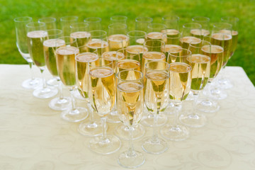 many of the champagne glasses on a buffet table. party in open air
