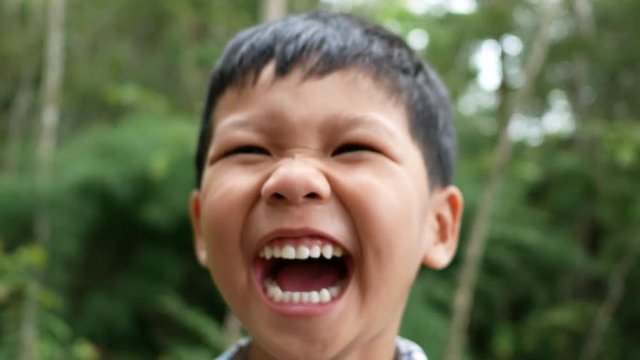 Close up face boy laugh.