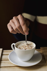 young man with a cup of cappuccino