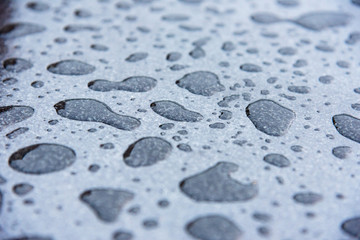 Closeup drops of water on the car after rain.
