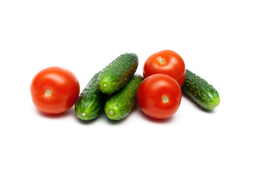 Ripe tomatoes and cucumbers isolated on white background