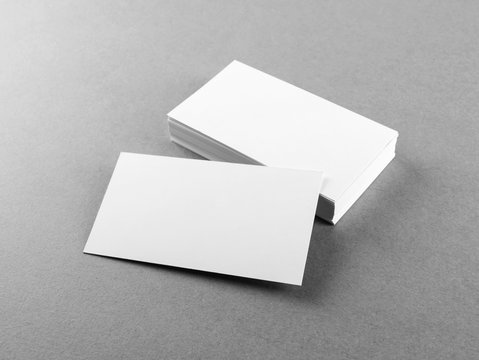 Photo of blank business cards on gray paper background. Template for branding identity. Mockup for ID. Studio shot.