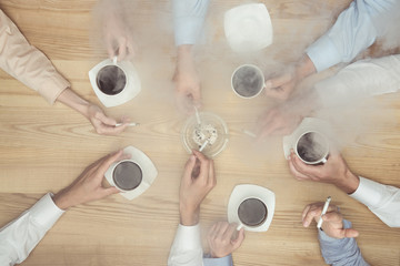 top view of businesspeople smoking on coffee break on wooden tabletop