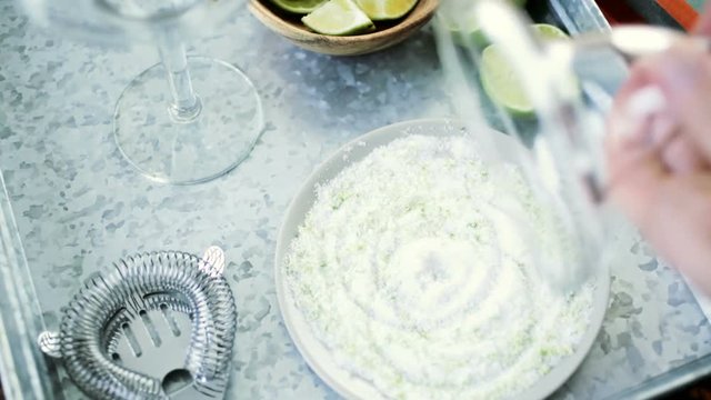 Time-lapse. Salting rimme of glass for key lime margarita