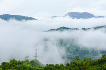 Eletric power transmission system  on hill covering with fog