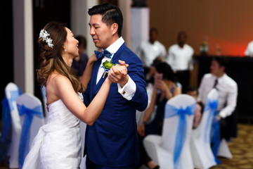 Obraz premium First dance of an attractive Asian couple
