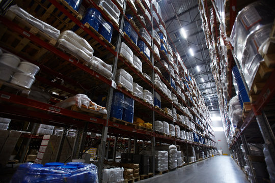 Low angle view of shelves and racks in empty warehouse