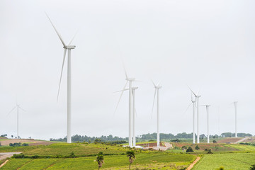 Power of wind turbine generating electricity clean energy with mist fog background.Global ecology.Clean energy concept save the world.