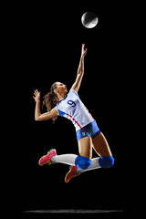 Female professional volleyball player isolated on black © 103tnn