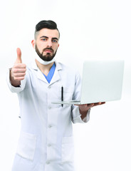 Doctor with beard holds white laptop and shows thumbs up