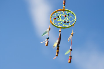 Dream catcher in the wind against the sky, selective focus