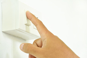 Human hands turn on the power switch.