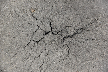 Cracks in the asphalt - obrazy, fototapety, plakaty