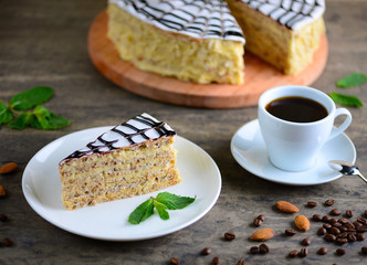 Delicious piece of esterhazy cake (torte). Morning cup of coffee with hungarian dessert. Food background with a copy space.