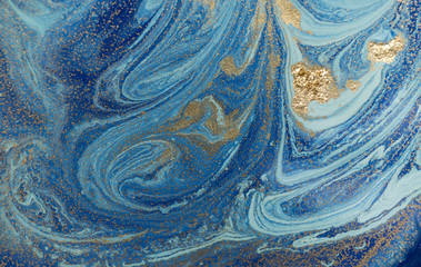 Marbled blue and golden abstract background. Liquid marble pattern