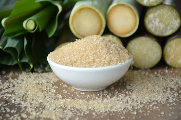 Brown sugar from sugarcane on  wooden table,Agriculture Industry concept.