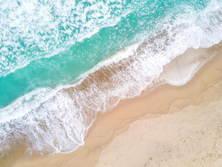 Fototapeta na wymiar Aerial view of sandy beach and ocean with waves
