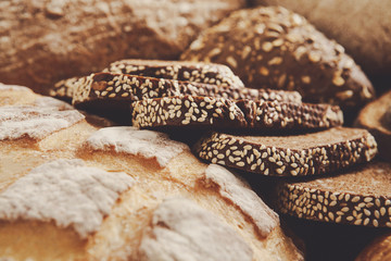 Bread background, closeup of white, black and rye loaves