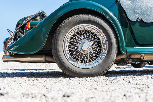 spoked rear wheel of a green morgan +8 cabriolet - oldtimer