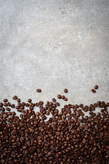 Roasted coffee beans on gray stone background. Close up