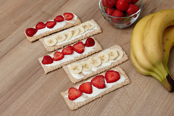 Healthy food. Fruit cut into bread and biscuits. A delicious dessert. Strawberry. Bananas. Fruits on a wooden background.Healthy food. Fruit cut into bread and biscuits. 