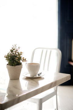 A cup of coffee on table in room,vintage filter,selective focus.