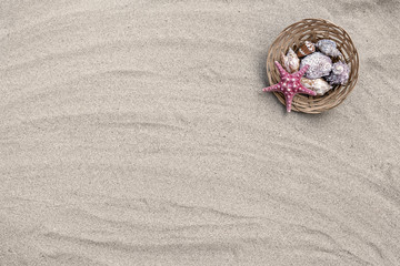 Starfish and seashells in basket on sand beach - 165442598