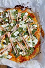 Healthy, diet pizza with rice bottom. Ham, spinach, feta cheese. 