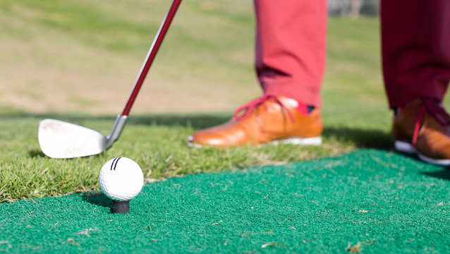 iron to ball and takes aim