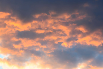 Naklejka na ściany i meble Photo of big fluffy orange clouds after sunset