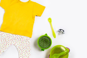 Baby clothes and accessories on white background. Top view