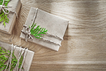 Fototapeta na wymiar Wrapped handmade gift boxes with green branch holidays concept