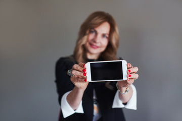 Woman shows her mobile phone screen