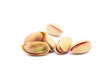 Pile of roasted pistachios isolated on white background