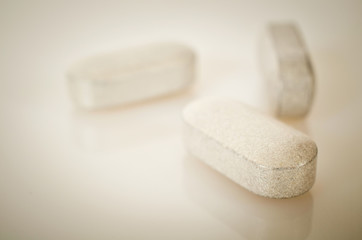 Fototapeta na wymiar Pharmacy theme, white medicine tablets antibiotic pills.