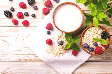 Raspberry, blackberry and blueberry, oatmeal breakfast with milk