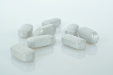 Pharmacy theme, white medicine tablets antibiotic pills.
