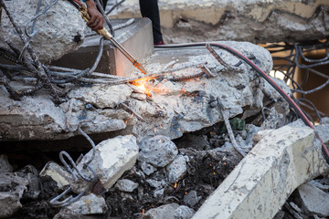 Technician cutting steel with gas and have fire sparkling in site construction.