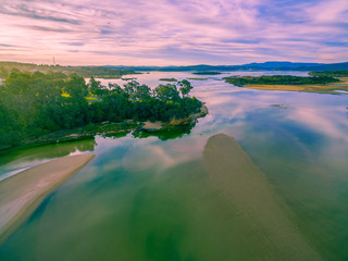 Aerial view of Wallagaraugh River mouth and Goat Island at sunset. Mallacoota, Victoria, Australia