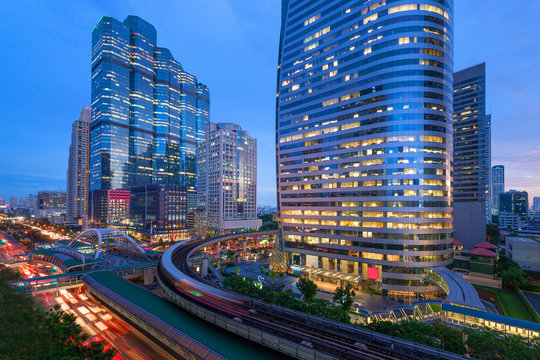Bangkok business intersection at dusk. Location is Sathorn-Naratiwas road with office buildings and hotels around.