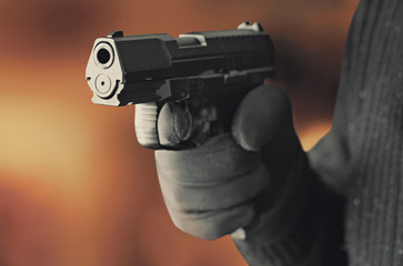 man with hand gun pistol rubber attack violence