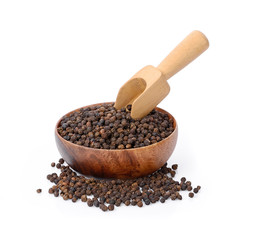 milled black pepper on wooden bowl
