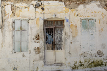 Fototapeta na wymiar Facade of an abandoned building in Paleo Karlovasi village on Samos island, Greece. 