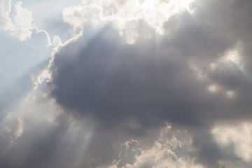 The sky and beam passing through the clouds.