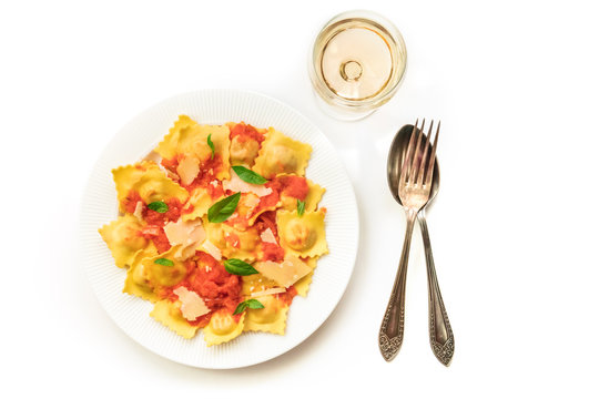 Plate Of Ravioli With Tomato Sauce And Wine On White