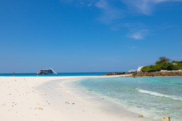 relaxing on the white sand beach at Racha island in Phuket Thailand